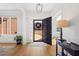 Bright foyer with hardwood floors, an elegant chandelier, and views of the front yard at 2105 Rotunda Ct, Conyers, GA 30094