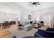 Bright, open-concept living room seamlessly connects to the kitchen and dining area with elegant hardwood floors at 2105 Rotunda Ct, Conyers, GA 30094