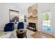 Elegant living room featuring a stone fireplace, comfortable seating, and a seamless connection to the outdoors at 2105 Rotunda Ct, Conyers, GA 30094