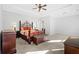 Spacious main bedroom with a decorative ceiling fan, carpet flooring and modern decor at 2105 Rotunda Ct, Conyers, GA 30094