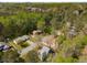 Expansive aerial view of houses surrounded by lush, mature trees on a large lot at 3021 Favor Pines Sw Ct, Marietta, GA 30060