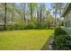 Spacious backyard with a lush green lawn and mature trees, perfect for outdoor activities at 3021 Favor Pines Sw Ct, Marietta, GA 30060