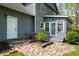Backyard patio features a stone pathway and lush green landscape with a door to the main house at 3021 Favor Pines Sw Ct, Marietta, GA 30060