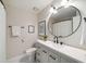 Updated bathroom features a round mirror, updated sink and a shower-tub combo with updated fixtures at 3021 Favor Pines Sw Ct, Marietta, GA 30060
