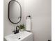 Charming bathroom with a sleek black faucet, oval mirror, and a fresh green plant at 3021 Favor Pines Sw Ct, Marietta, GA 30060