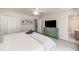 Inviting bedroom with a large flat screen TV, neutral walls, and attached bathroom at 3021 Favor Pines Sw Ct, Marietta, GA 30060