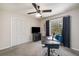 Cozy carpeted bedroom featuring a ceiling fan, closet, and an abundance of natural light at 3021 Favor Pines Sw Ct, Marietta, GA 30060