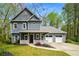 Charming two-story home with a covered front porch, attached garage, and well-manicured lawn and landscape at 3021 Favor Pines Sw Ct, Marietta, GA 30060