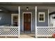 Cozy covered porch showing a stained glass front door, trimmed in white lattice at 3021 Favor Pines Sw Ct, Marietta, GA 30060