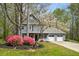 Charming two-story home with gray siding, a cozy porch, and vibrant pink bushes at 3021 Favor Pines Sw Ct, Marietta, GA 30060