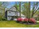 Charming two-story home with gray siding, a cozy porch, and vibrant pink bushes at 3021 Favor Pines Sw Ct, Marietta, GA 30060