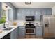 Well-lit kitchen features ample counter space, modern appliances, and updated cabinets at 3021 Favor Pines Sw Ct, Marietta, GA 30060