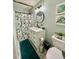 Bright bathroom features a shower and tub combination, white vanity and a white toilet at 684 N Cherokee N Rd, Social Circle, GA 30025