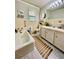 Well-lit bathroom featuring tile walls and floors, bathtub, and a vanity with a sink at 684 N Cherokee N Rd, Social Circle, GA 30025