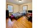 Bedroom featuring hardwood floors, a full bed, desk, and natural light from two windows at 684 N Cherokee N Rd, Social Circle, GA 30025