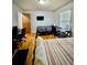Bedroom with hardwood flooring, two beds, two desks, and natural light from a window at 684 N Cherokee N Rd, Social Circle, GA 30025