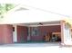 Covered carport with exposed brick columns and storage space at 684 N Cherokee N Rd, Social Circle, GA 30025