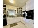 Traditional kitchen features white cabinets, black appliances, and natural light at 684 N Cherokee N Rd, Social Circle, GA 30025