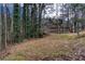 Sloping backyard leading to a peaceful pond, surrounded by mature trees at 875 Edgewater Cir, Marietta, GA 30062