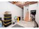 Unfinished basement with exposed wood ceiling and stairs leading to another level at 875 Edgewater Cir, Marietta, GA 30062