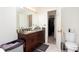 Bathroom featuring double sinks, granite countertops, and a classic-style toilet at 875 Edgewater Cir, Marietta, GA 30062