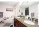 Bathroom featuring granite countertops, double sinks, soaking tub, and decorative accents at 875 Edgewater Cir, Marietta, GA 30062