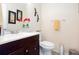 Clean and functional half bathroom with vanity, toilet, and decor at 875 Edgewater Cir, Marietta, GA 30062