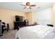 Bedroom featuring a large bed, television, and mini-refrigerator, perfect for relaxation at 875 Edgewater Cir, Marietta, GA 30062