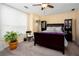 This bedroom has a carpeted floor, ceiling fan, large window, and is furnished with a bed and cabinets at 875 Edgewater Cir, Marietta, GA 30062