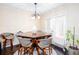 Formal dining area featuring a modern chandelier, dining table, and patio door at 875 Edgewater Cir, Marietta, GA 30062