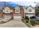 A home's exterior view shows the driveway and attached garages, and a well manicured yard at 875 Edgewater Cir, Marietta, GA 30062