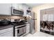 This charming kitchen offers stainless steel appliances and a view into the dining area at 875 Edgewater Cir, Marietta, GA 30062