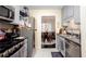 Efficient kitchen layout with stainless appliances offering sight lines to the dining area at 875 Edgewater Cir, Marietta, GA 30062
