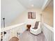 Second floor landing with carpeted flooring and an inviting lounge chair at 875 Edgewater Cir, Marietta, GA 30062