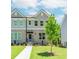 Charming townhome with brick facade, gray siding, manicured lawn and inviting front entrance at 1250 Ainsworth Aly # 42, Sugar Hill, GA 30518