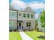 Charming townhome with brick facade, gray siding, manicured lawn and inviting front entrance at 1250 Ainsworth Aly # 42, Sugar Hill, GA 30518