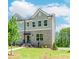 Charming townhome with brick facade, gray siding, manicured lawn and inviting front entrance at 1250 Ainsworth Aly # 42, Sugar Hill, GA 30518