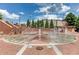 Splash pad in Sugar Hill features multiple water fountains surrounded by brick and landscaped areas at 1250 Ainsworth Aly # 42, Sugar Hill, GA 30518