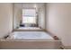 Large jetted tub in a spacious bathroom, perfect for unwinding after a long day at 2887 Swarthmore Dr, Lawrenceville, GA 30044