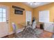 Cozy dining area featuring a glass table, mini fridge, and bright, sunny windows at 2887 Swarthmore Dr, Lawrenceville, GA 30044