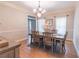 Formal dining room with hardwood floors, chandelier, and farmhouse-style table at 2887 Swarthmore Dr, Lawrenceville, GA 30044