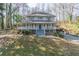 Two-story home with a charming front porch, blue accents, and a view of a sloped front yard at 2887 Swarthmore Dr, Lawrenceville, GA 30044