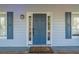 Classic front door with sidelights and decorative hardware, framed by elegant blue shutters at 2887 Swarthmore Dr, Lawrenceville, GA 30044