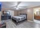 Relaxing main bedroom with gray wood floors, stone accent wall, and private bath access at 2887 Swarthmore Dr, Lawrenceville, GA 30044