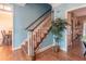 Elegant staircase featuring wood treads and white risers, adjacent to a decorative plant at 2887 Swarthmore Dr, Lawrenceville, GA 30044
