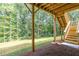 Backyard view of a wooden deck and steps overlooking a lush green lawn and wooded area at 939 Jean Ct, Covington, GA 30014
