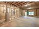 An unfinished basement with stud framing offers a blank canvas for customization at 939 Jean Ct, Covington, GA 30014