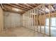 An unfinished basement with stud framing and walkout offers a blank canvas for customization at 939 Jean Ct, Covington, GA 30014