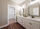 Bathroom with a double sink vanity, modern fixtures, framed mirrors, and a walk-in closet at 939 Jean Ct, Covington, GA 30014