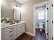 Bathroom boasts modern vanity with quartz countertop, framed mirror, and natural lighting at 939 Jean Ct, Covington, GA 30014